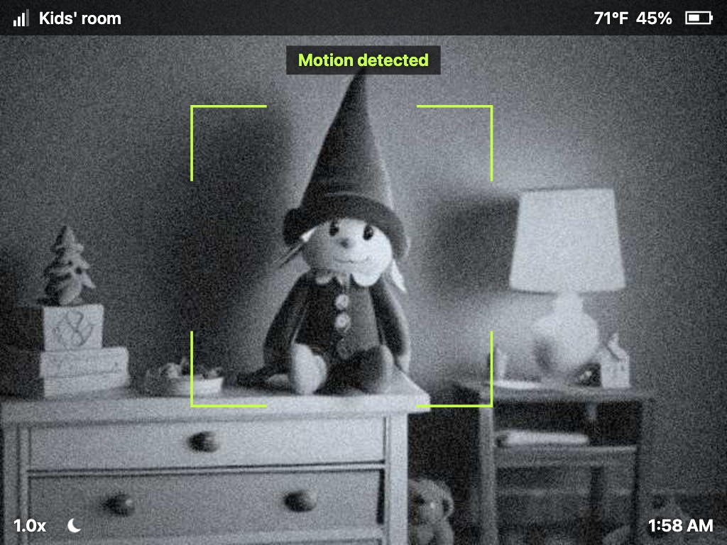 Baby monitor look: grainy infrared, a status bar with signal, room name, temperature and battery, and a Motion detected alert